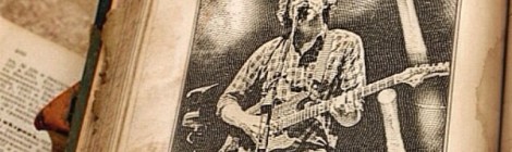 Black and white drawing of Trey singing and playing guitar on a page in a book