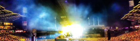 Picture of concert crowd with bright stage lights in center